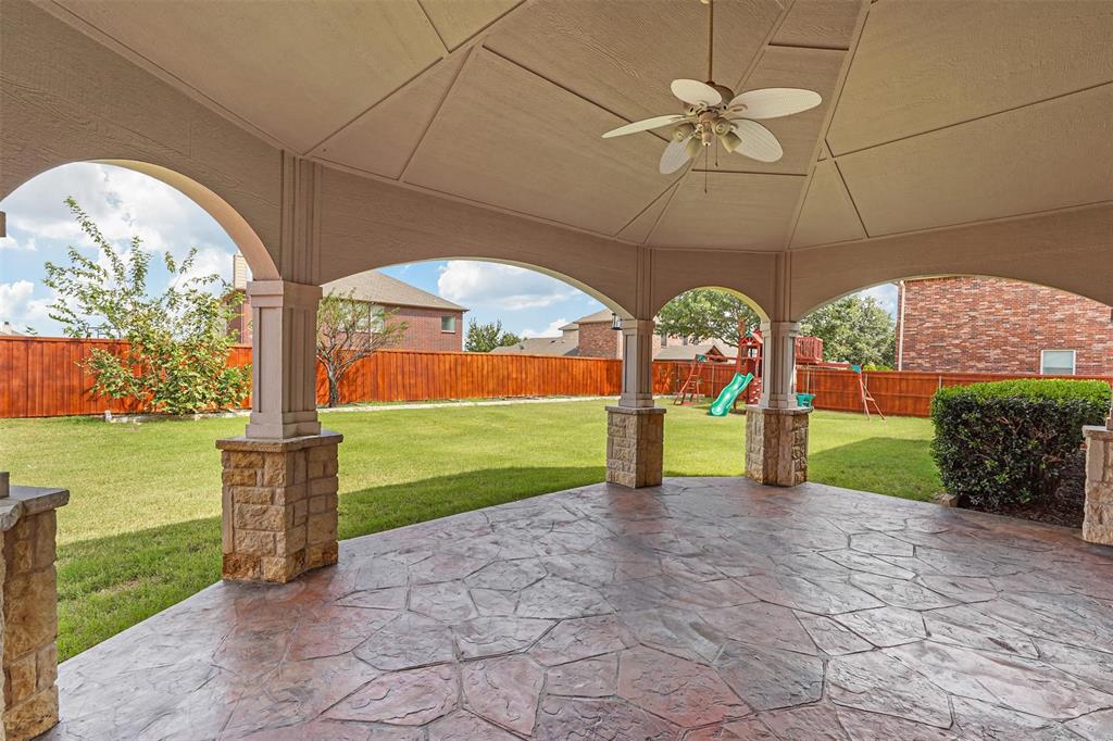 a view of a big room with a big yard and large tree