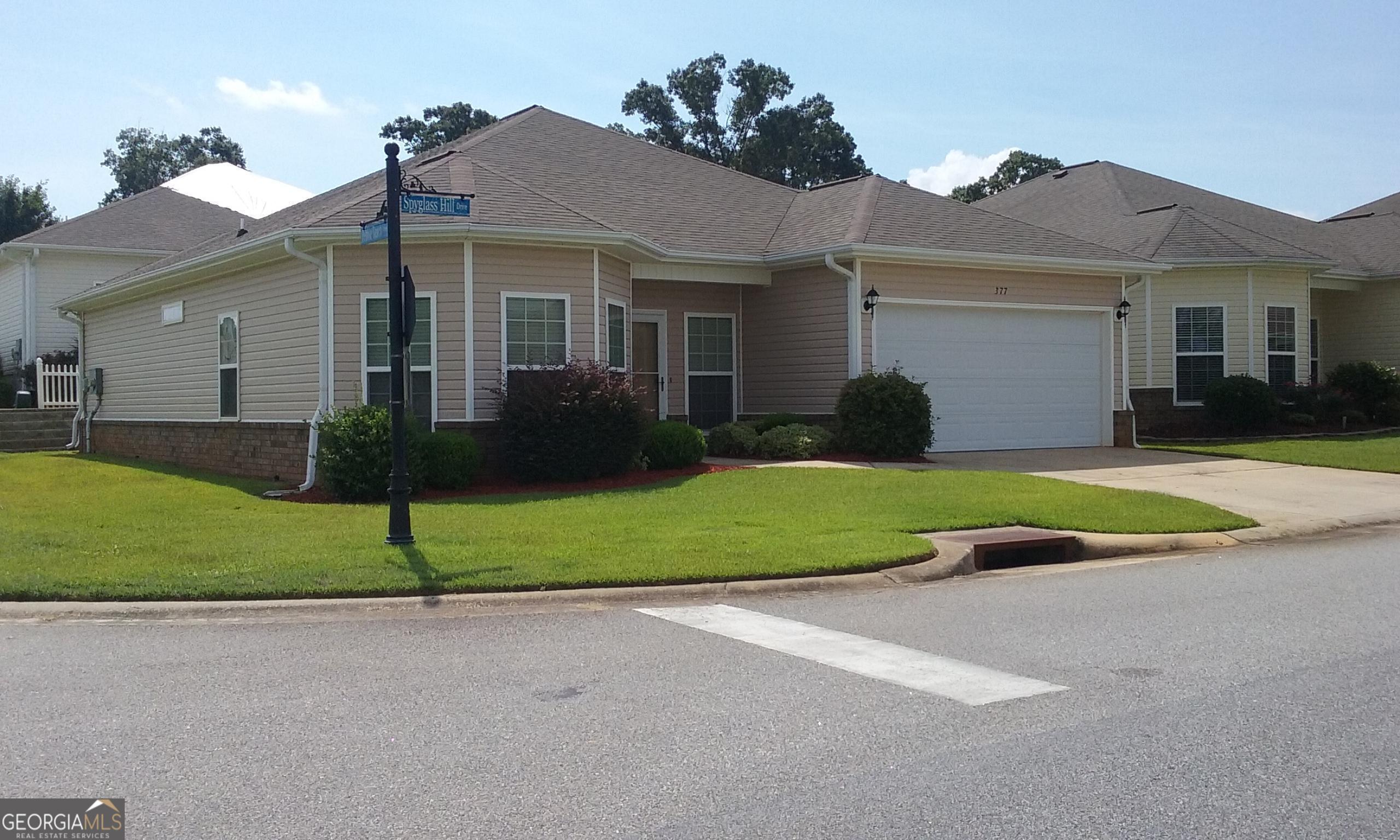 a view of a house with a yard and plants