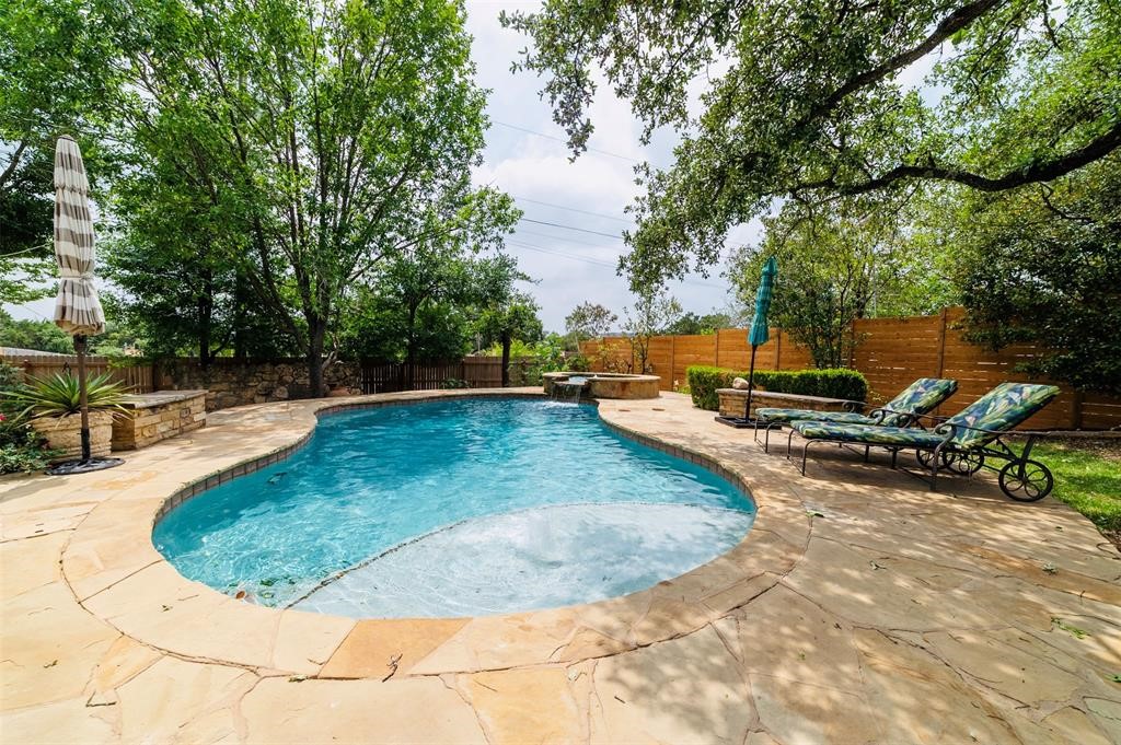 a view of a swimming pool with an outdoor seating