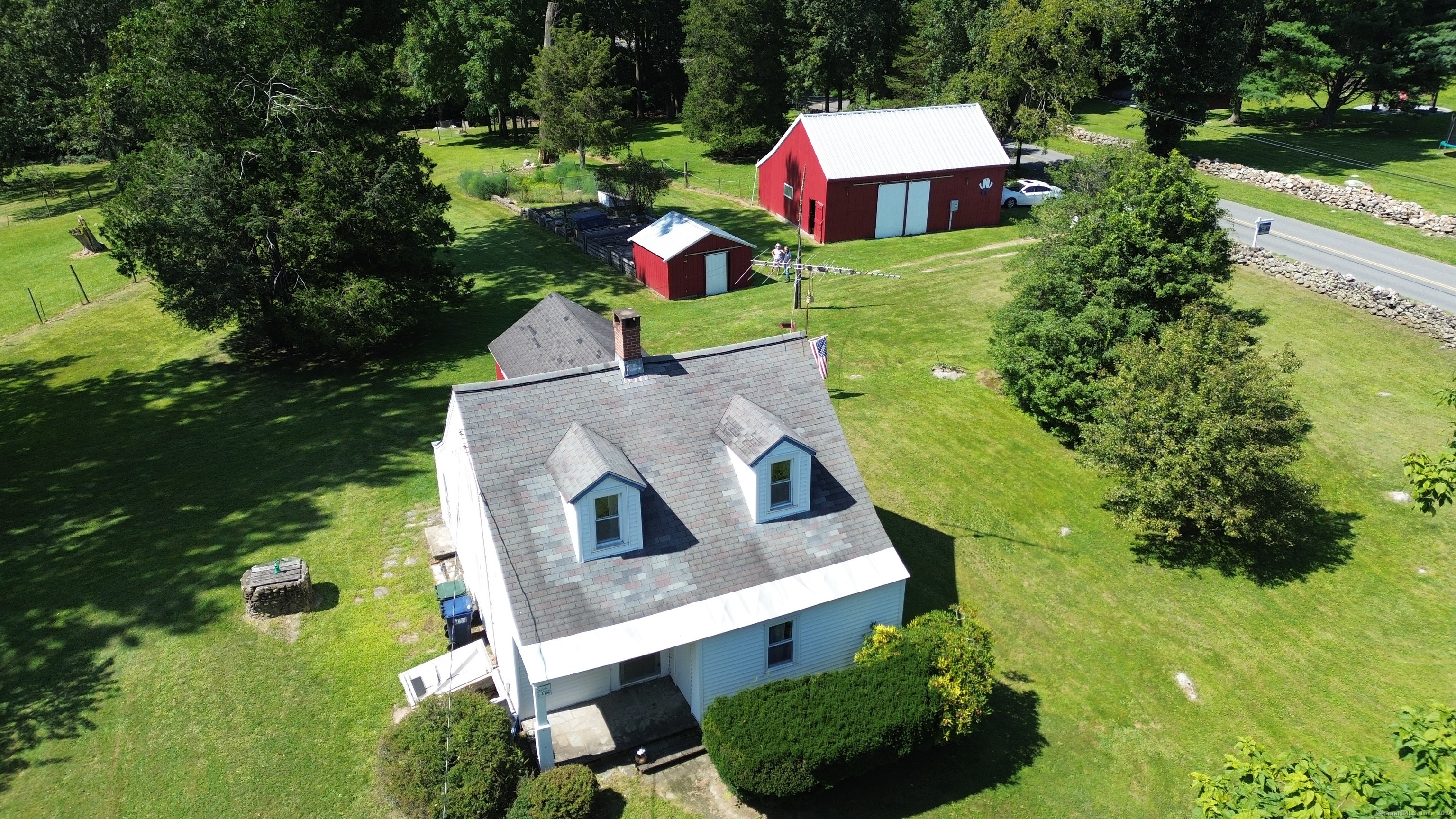 a aerial view of a house with swimming pool and yard