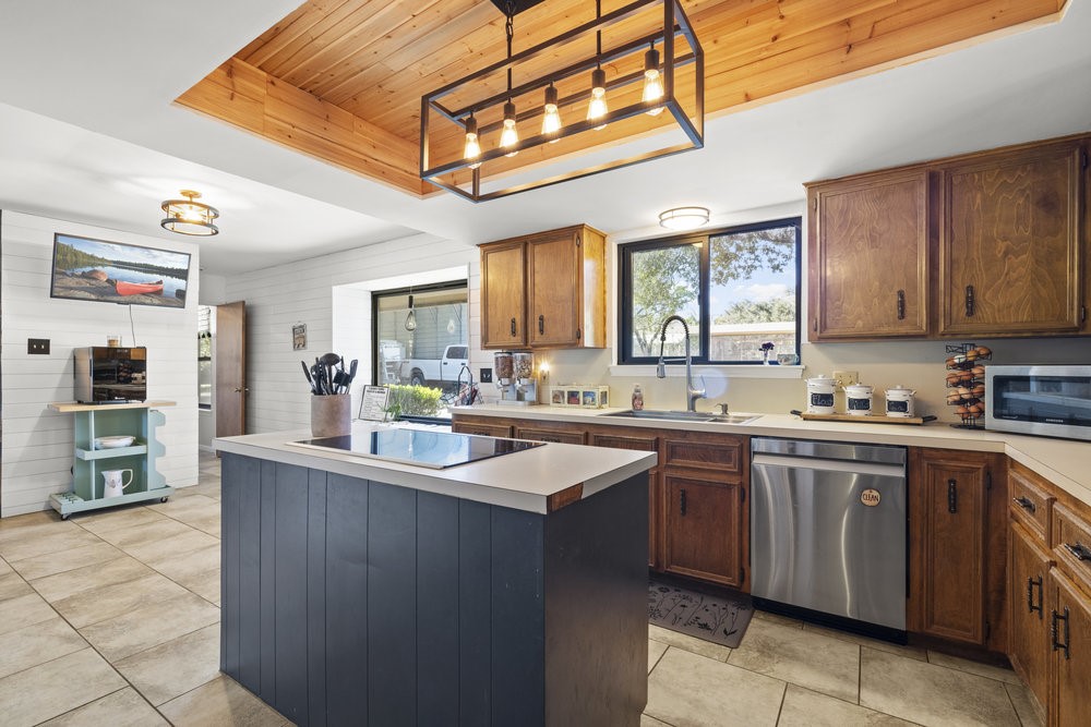 a kitchen with stainless steel appliances granite countertop a sink and cabinets