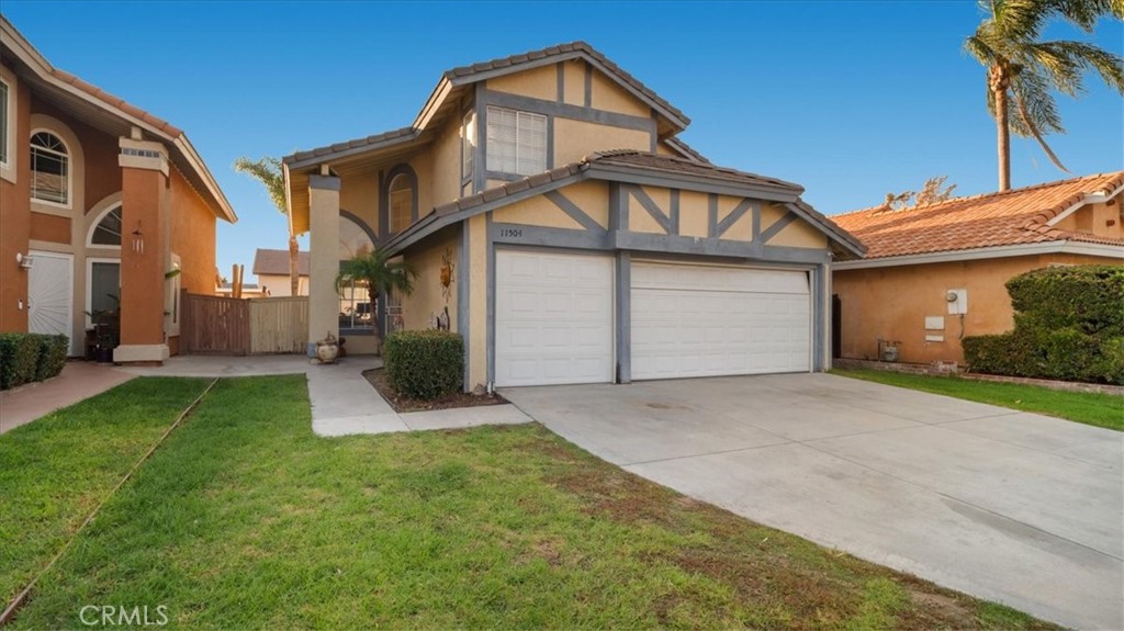 a front view of a house with a yard and garage