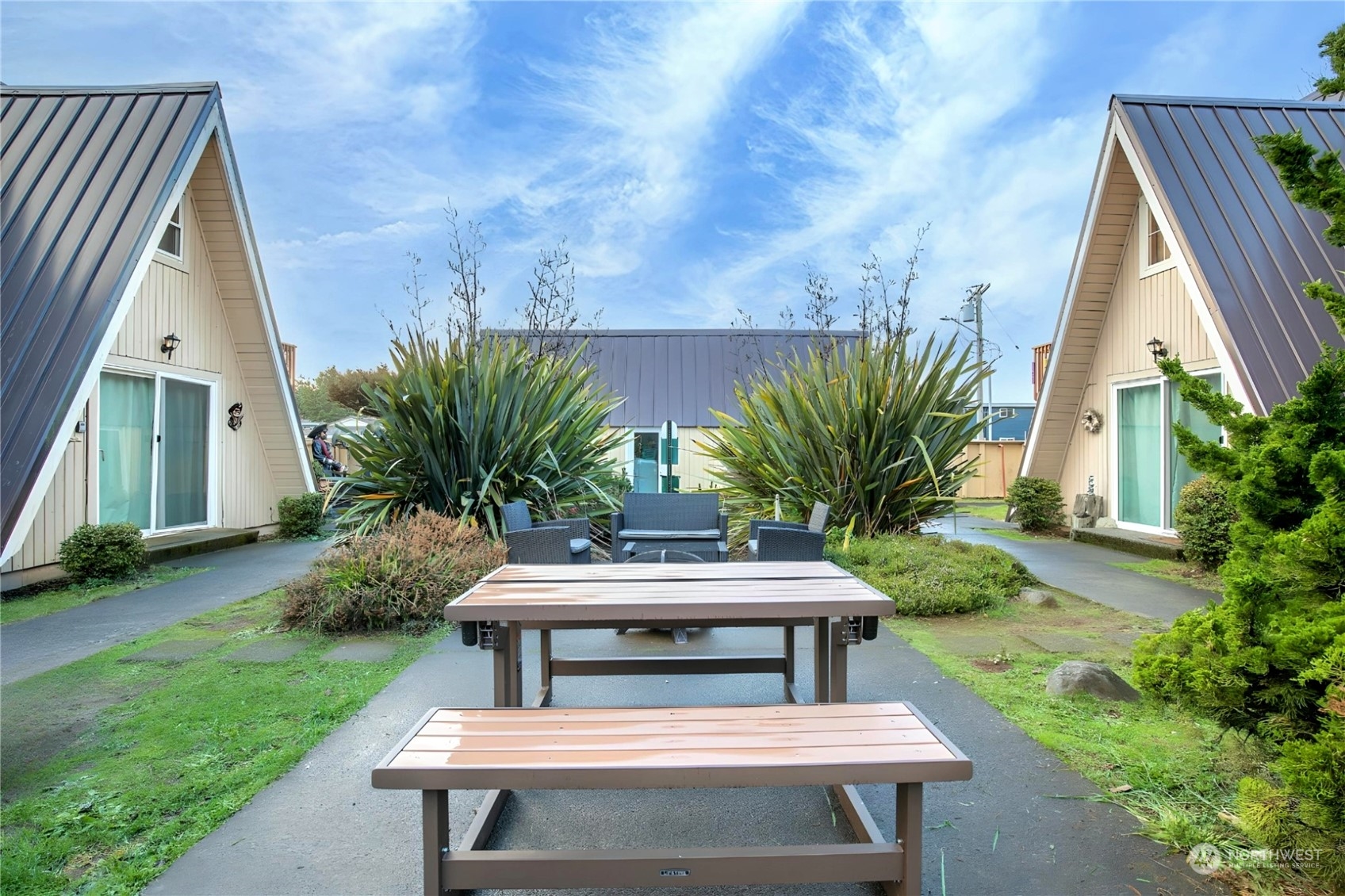 a view of a backyard with plants and outdoor seating