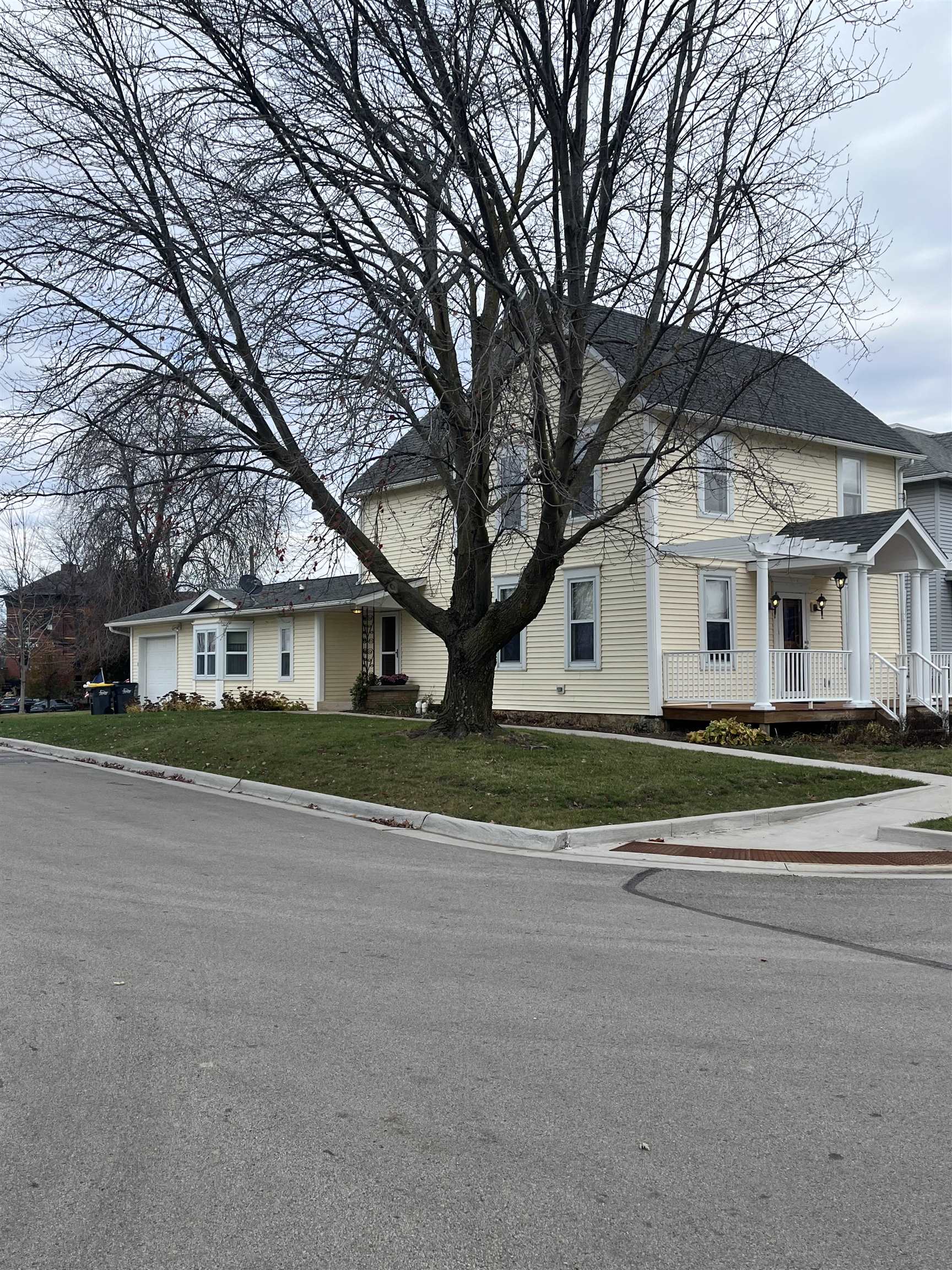 a front view of house with yard and trees