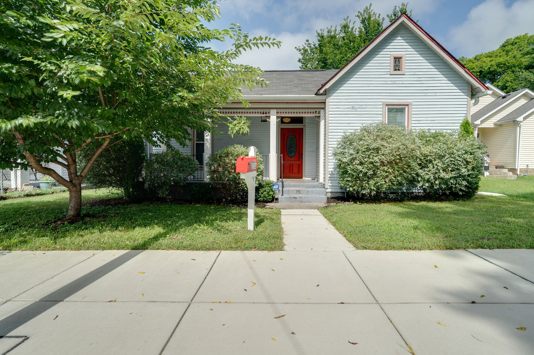 a front view of house with yard and green space