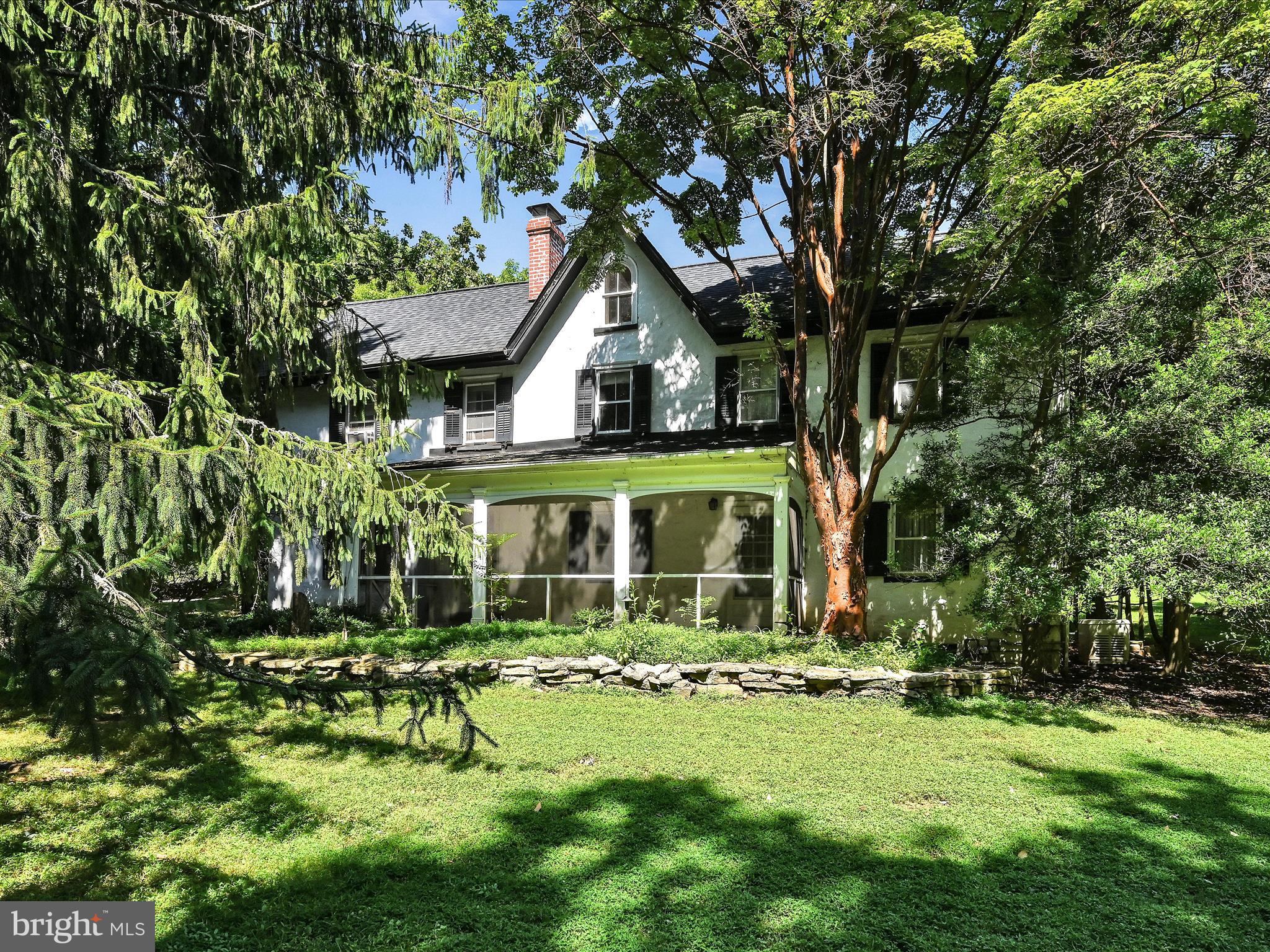 a house that has a tree in front of it