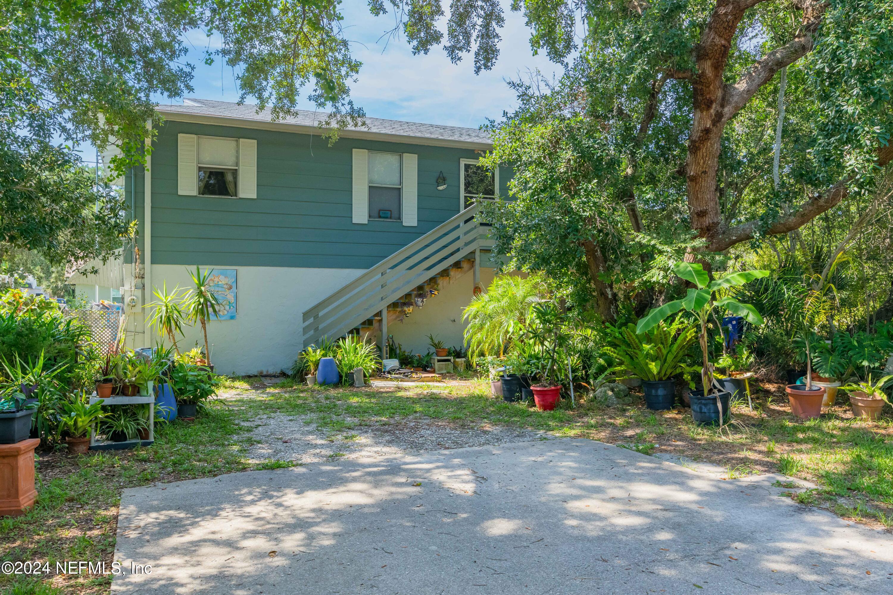 a backyard of a house with plants and trees