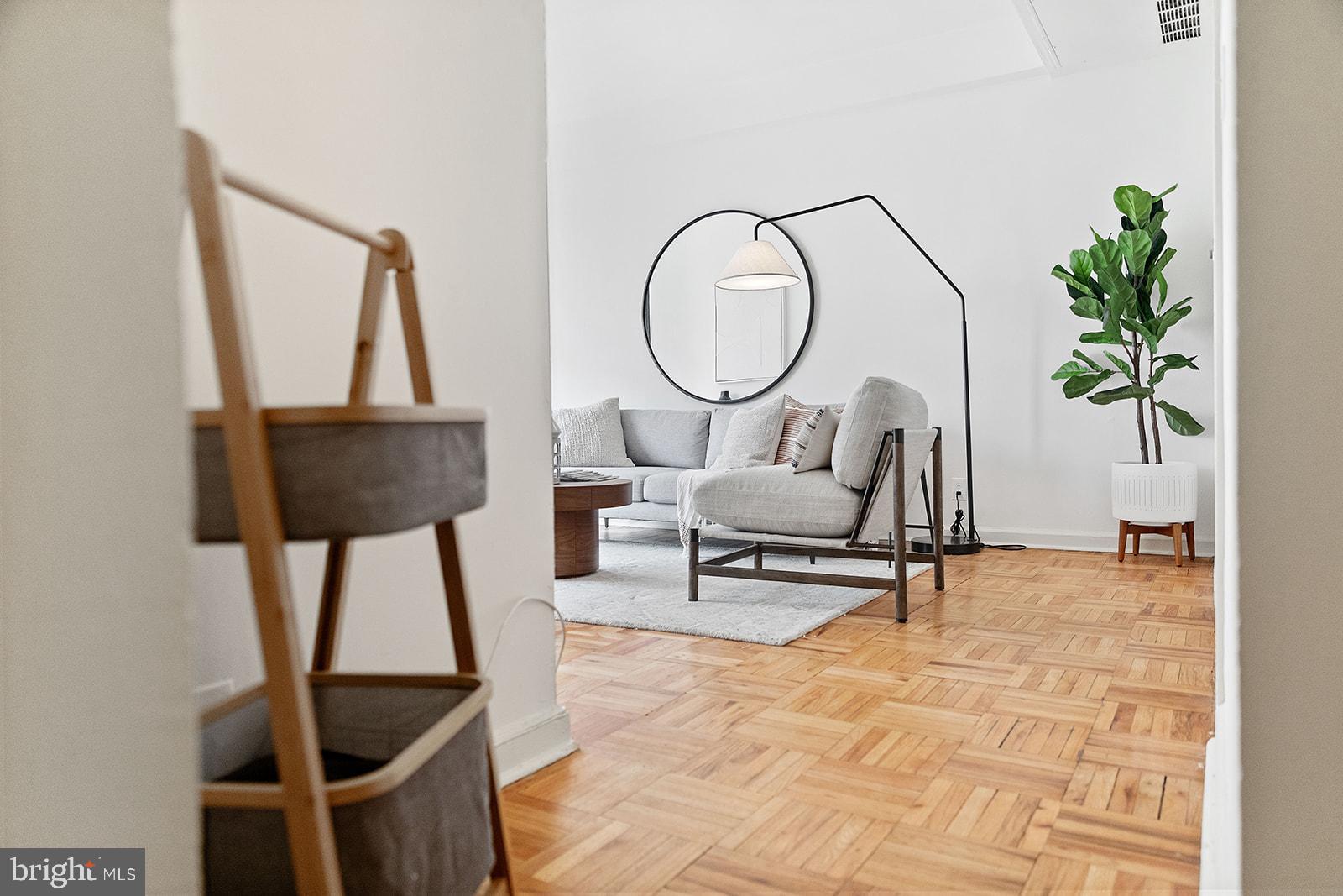 a living room with furniture and a potted plant