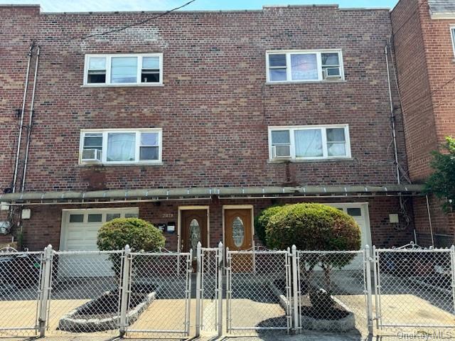 a brick house with a bench in front of house