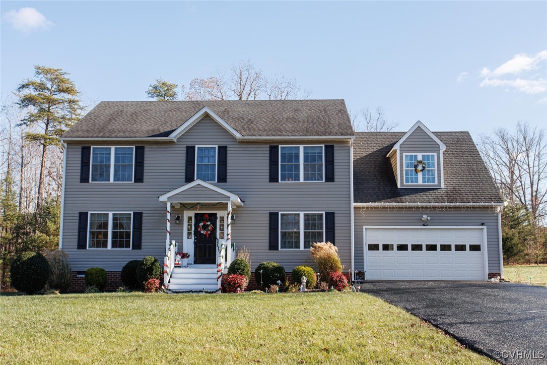 a front view of a house with a garden and plants