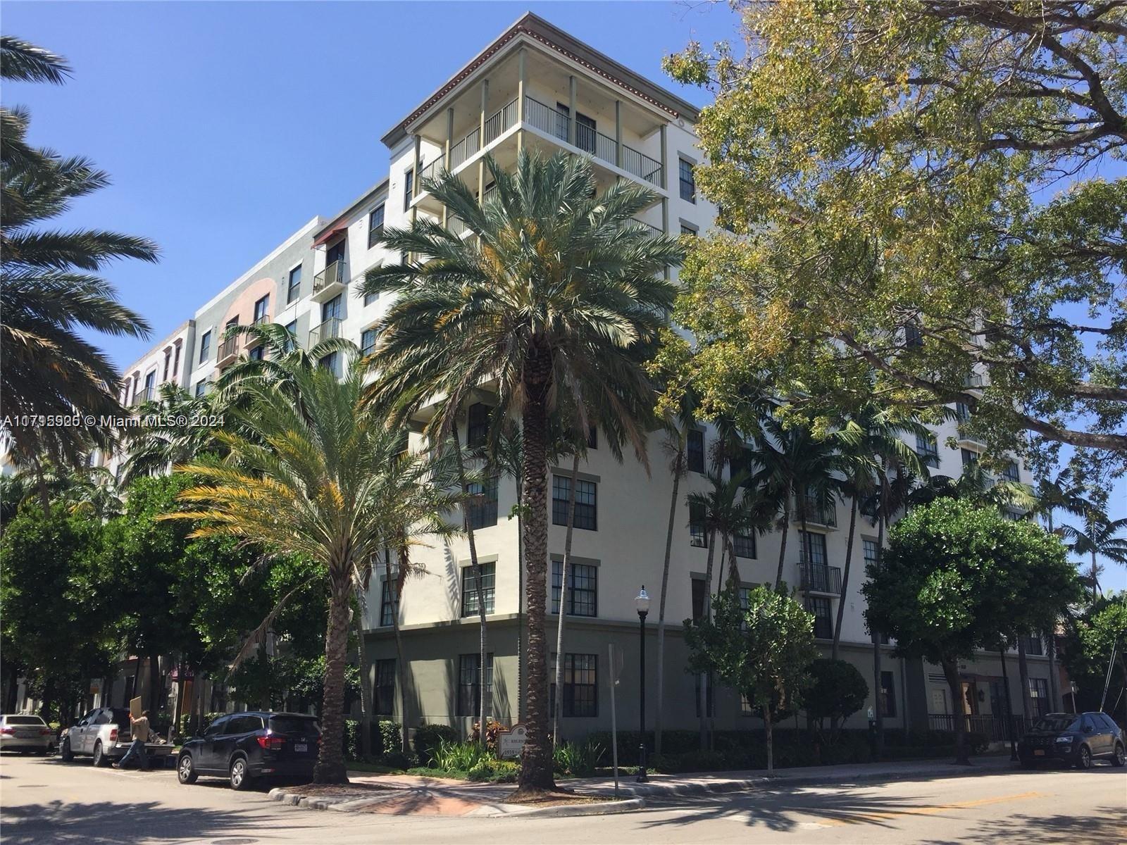 a front view of a building with tree s