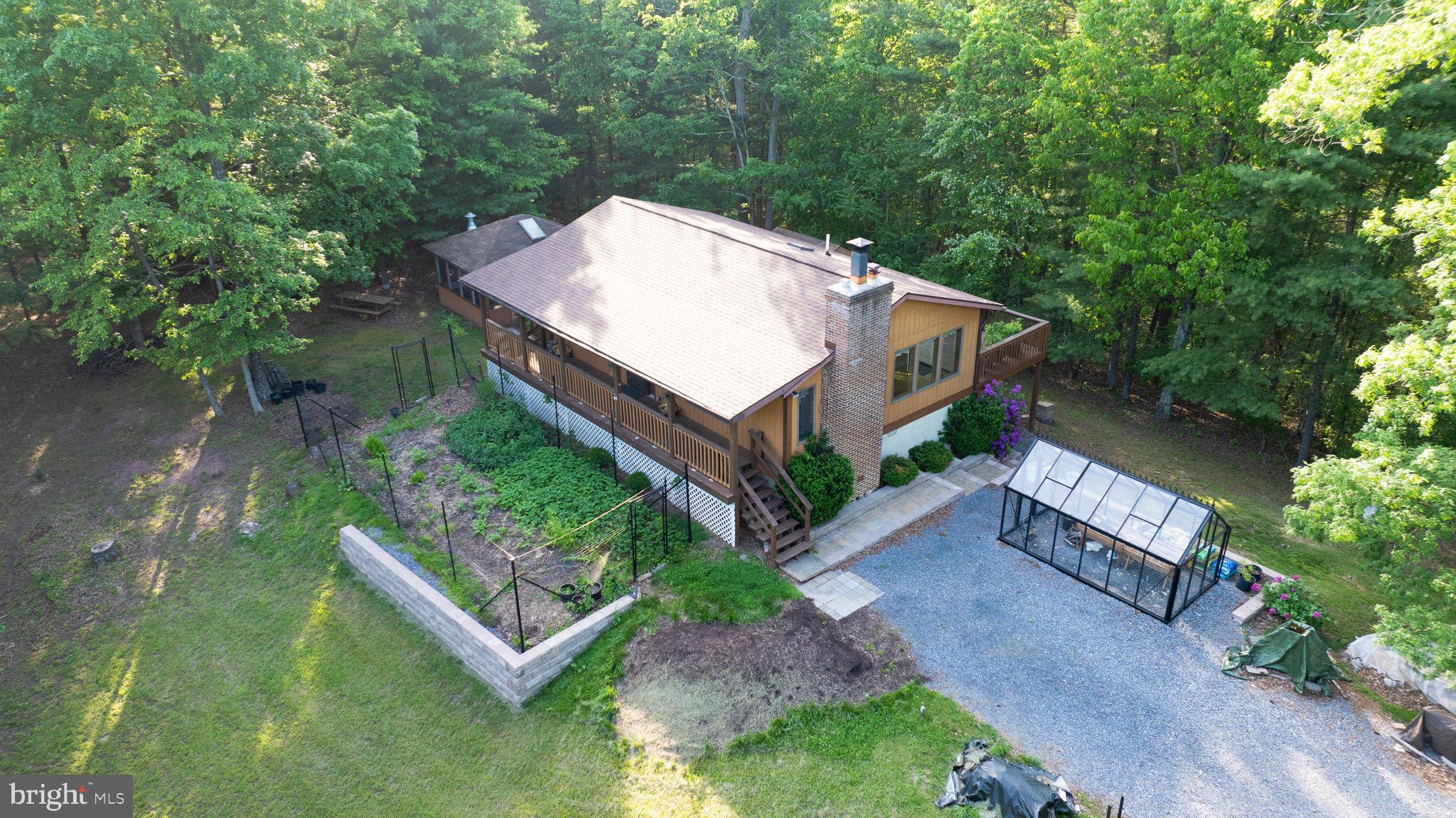 an aerial view of a house with a yard large tree and a yard