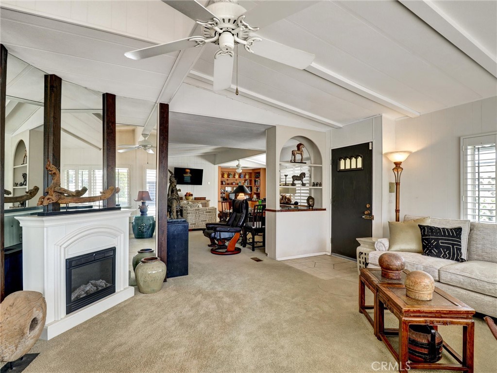 Lovely living area with fireplace and vaulted ceilings.