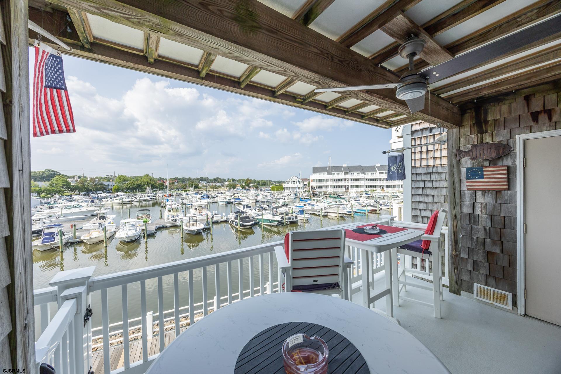 a balcony with a table and chairs