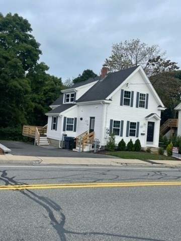 a view of a house next to a yard with road