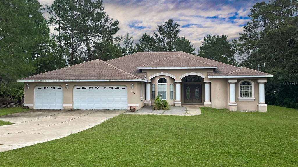 a front view of a house with garden