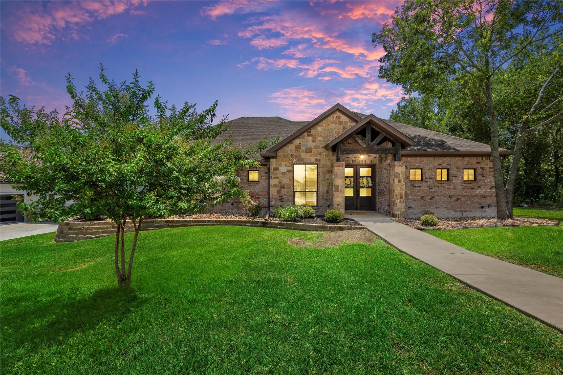 a front view of a house with a yard