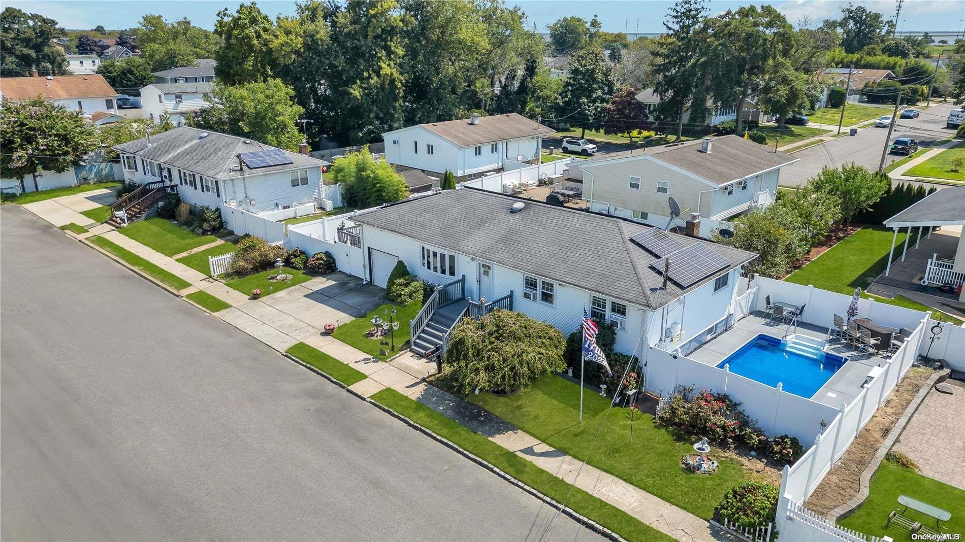 an aerial view of a house with garden space and street view