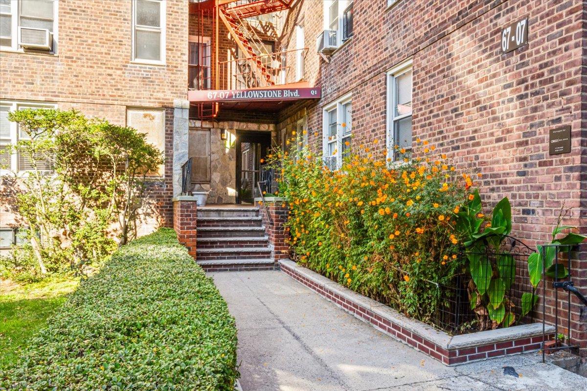 a view of a pathway of the house front of a house