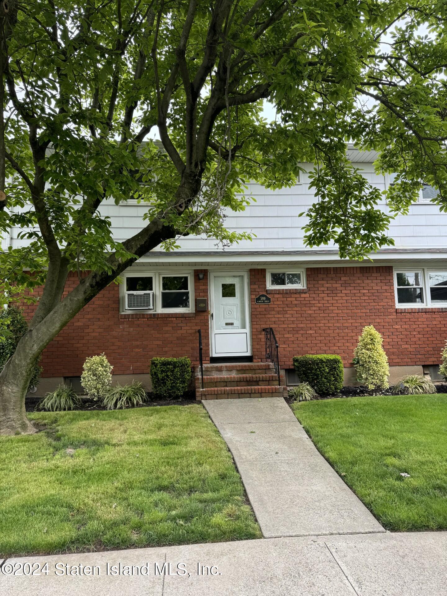 front view of a house with a yard