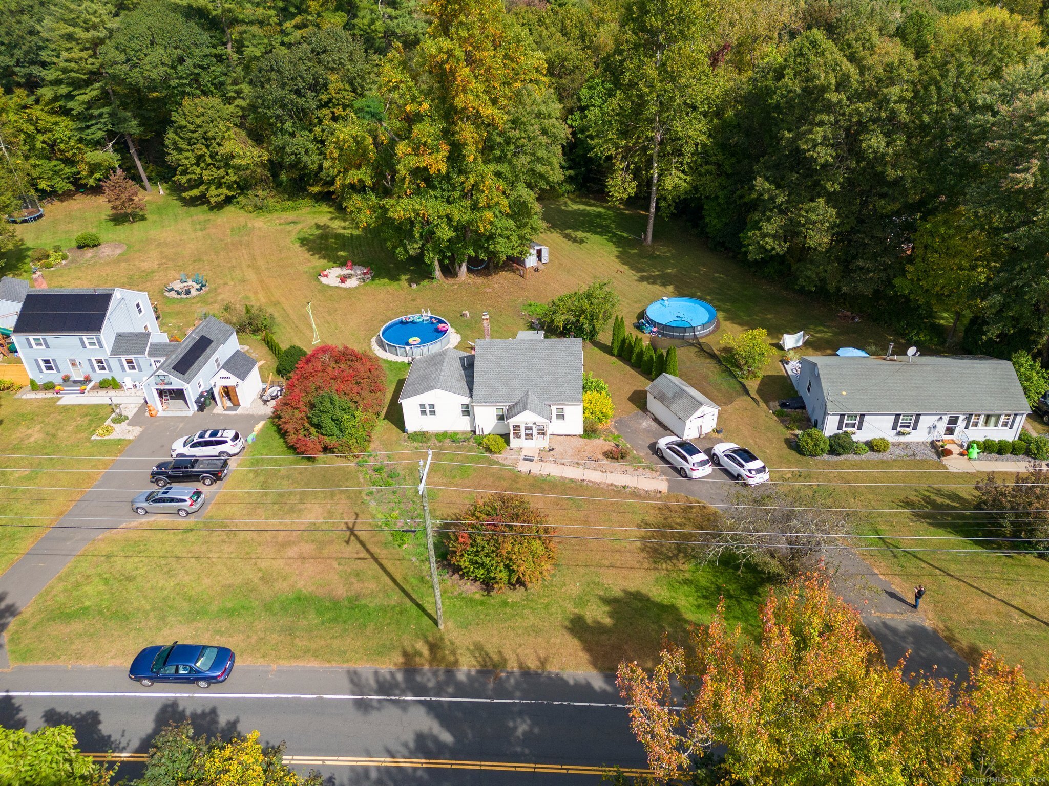 an aerial view of a house with a yard basket ball court