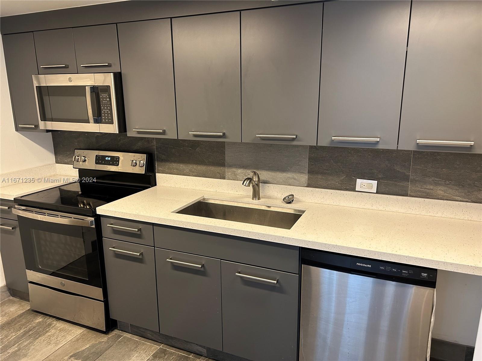 a kitchen with a sink and cabinets