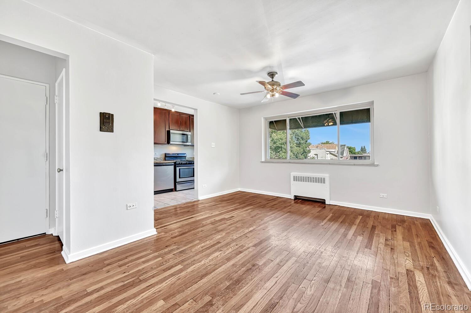 wooden floor in an empty room with a window