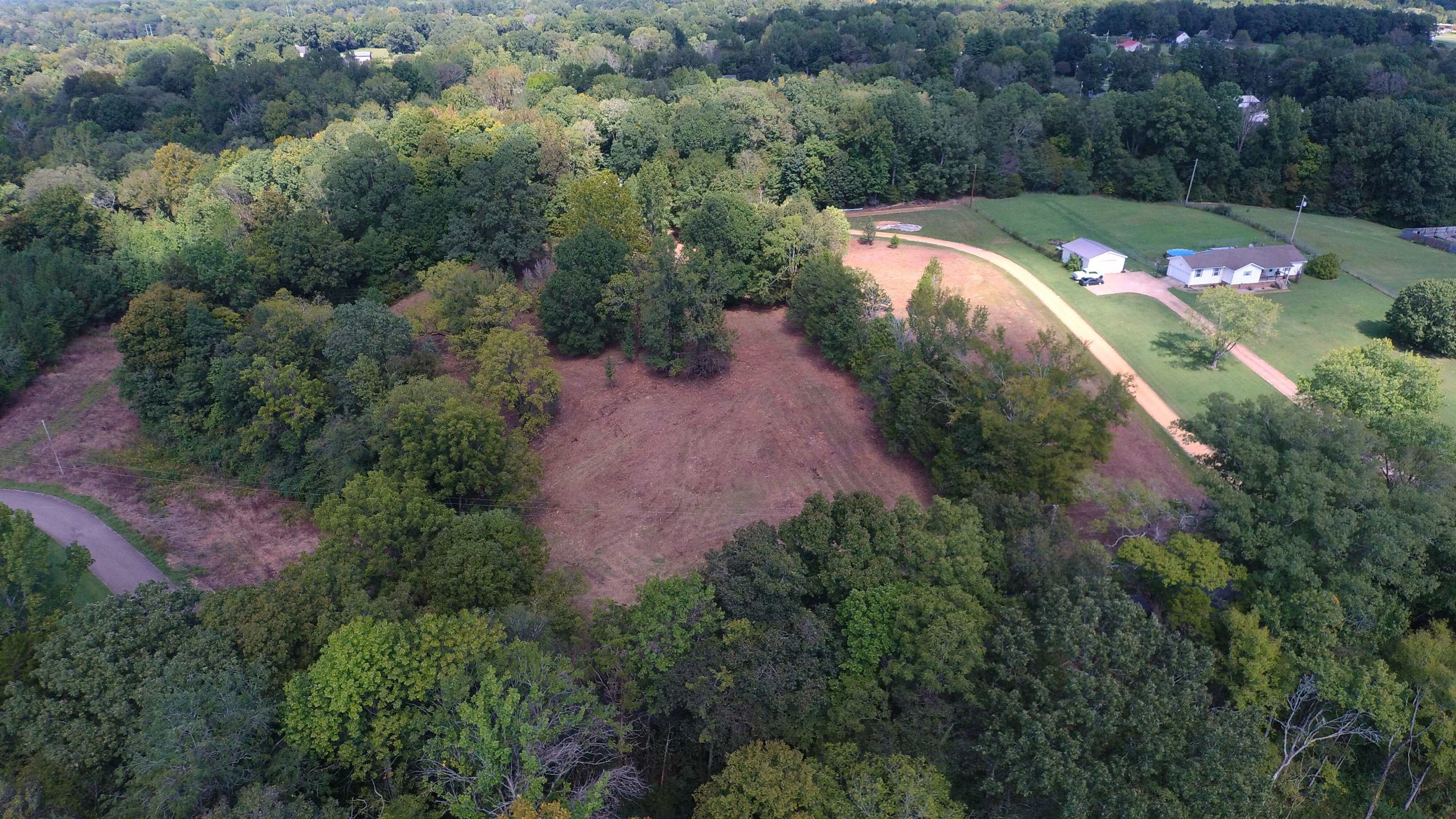 an aerial view of a house and a yard