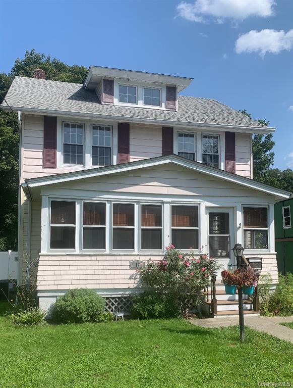 Front of house with 3 season porch.