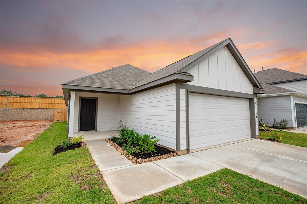 a front view of house with yard and car parked