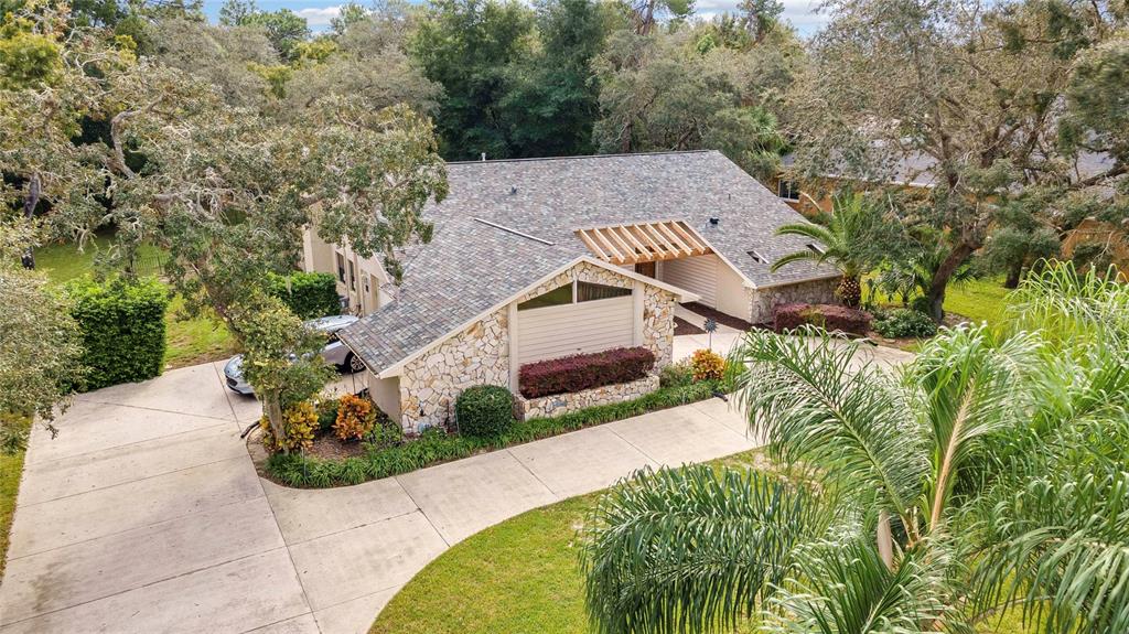 an aerial view of a house with a yard