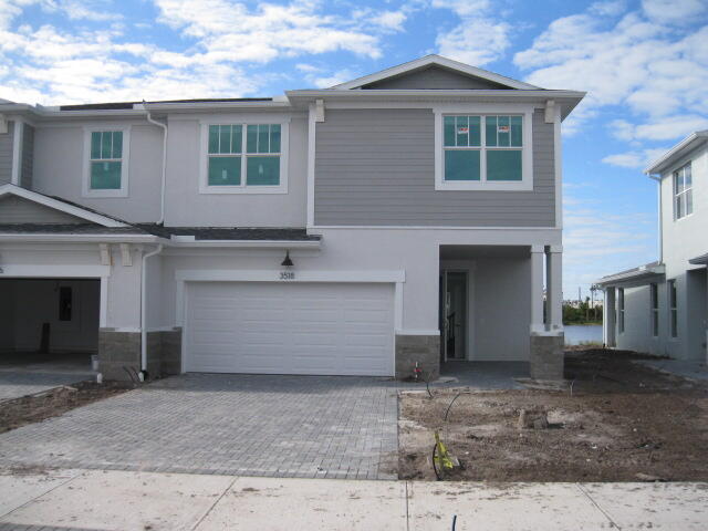 a front view of a house with a yard and garage