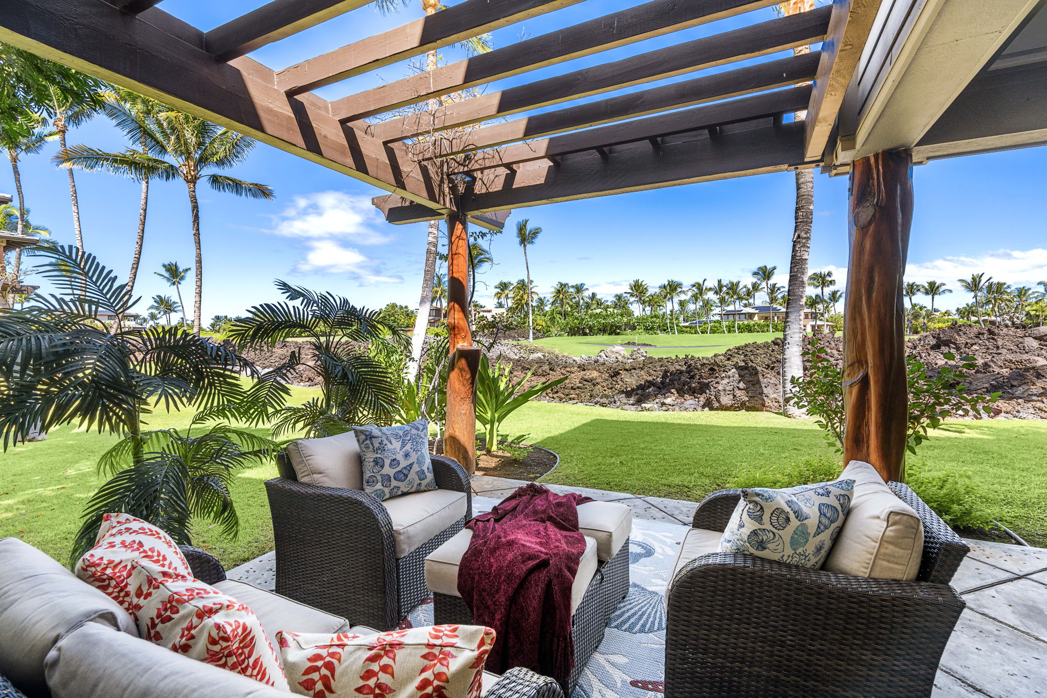 The extra-large lanai hosts a comfortable sitting area to enjoy a cocktail, visit with friends and family, or just relax and read while enjoying the view.