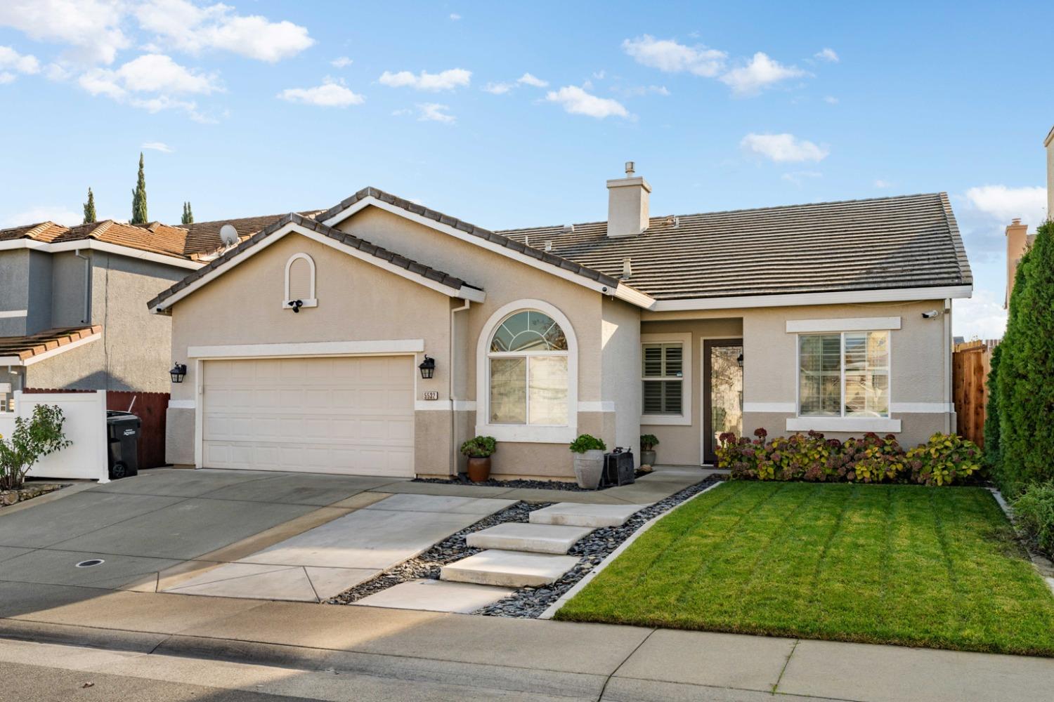 a front view of a house with a garden