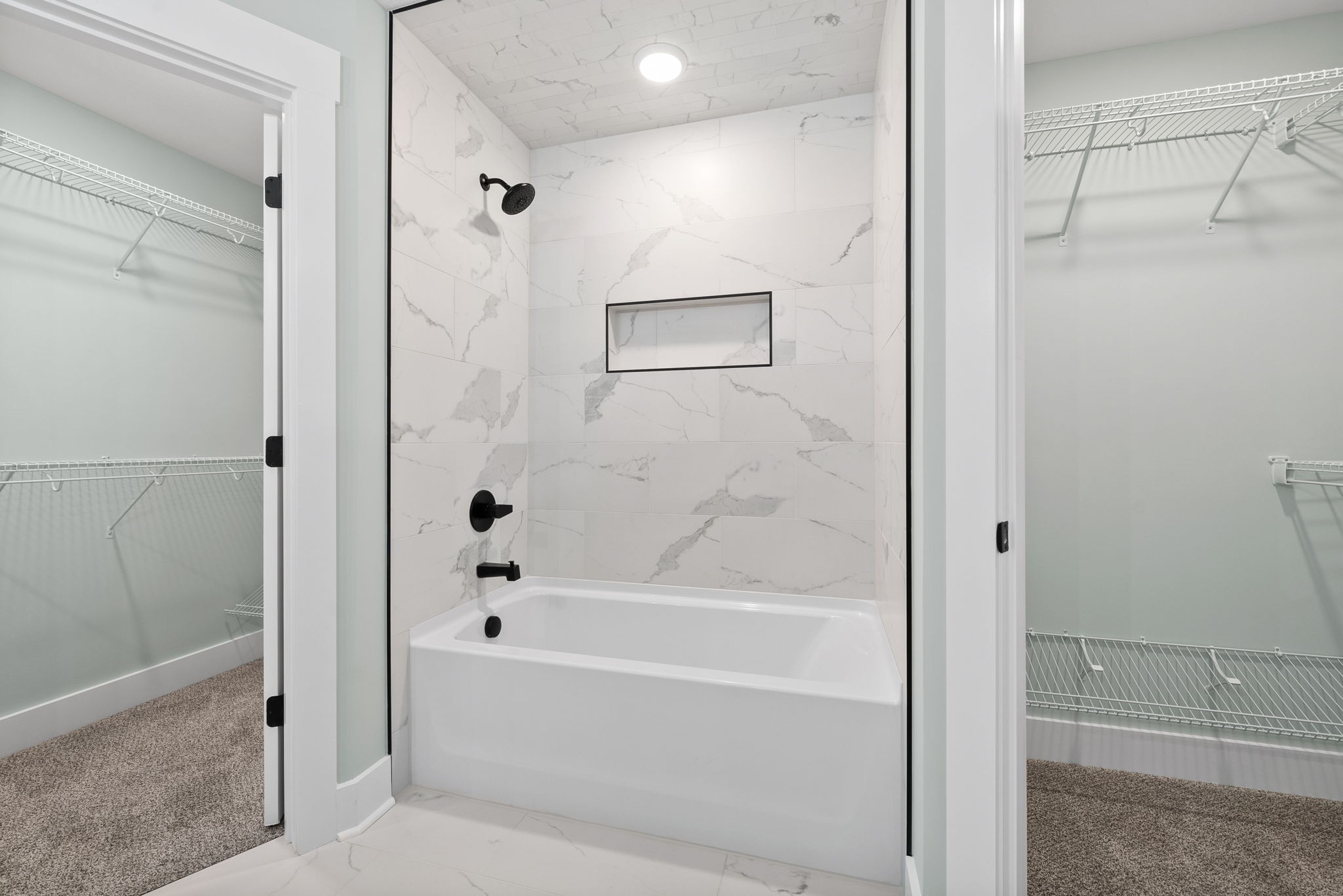 a bathroom with a bathtub and shower