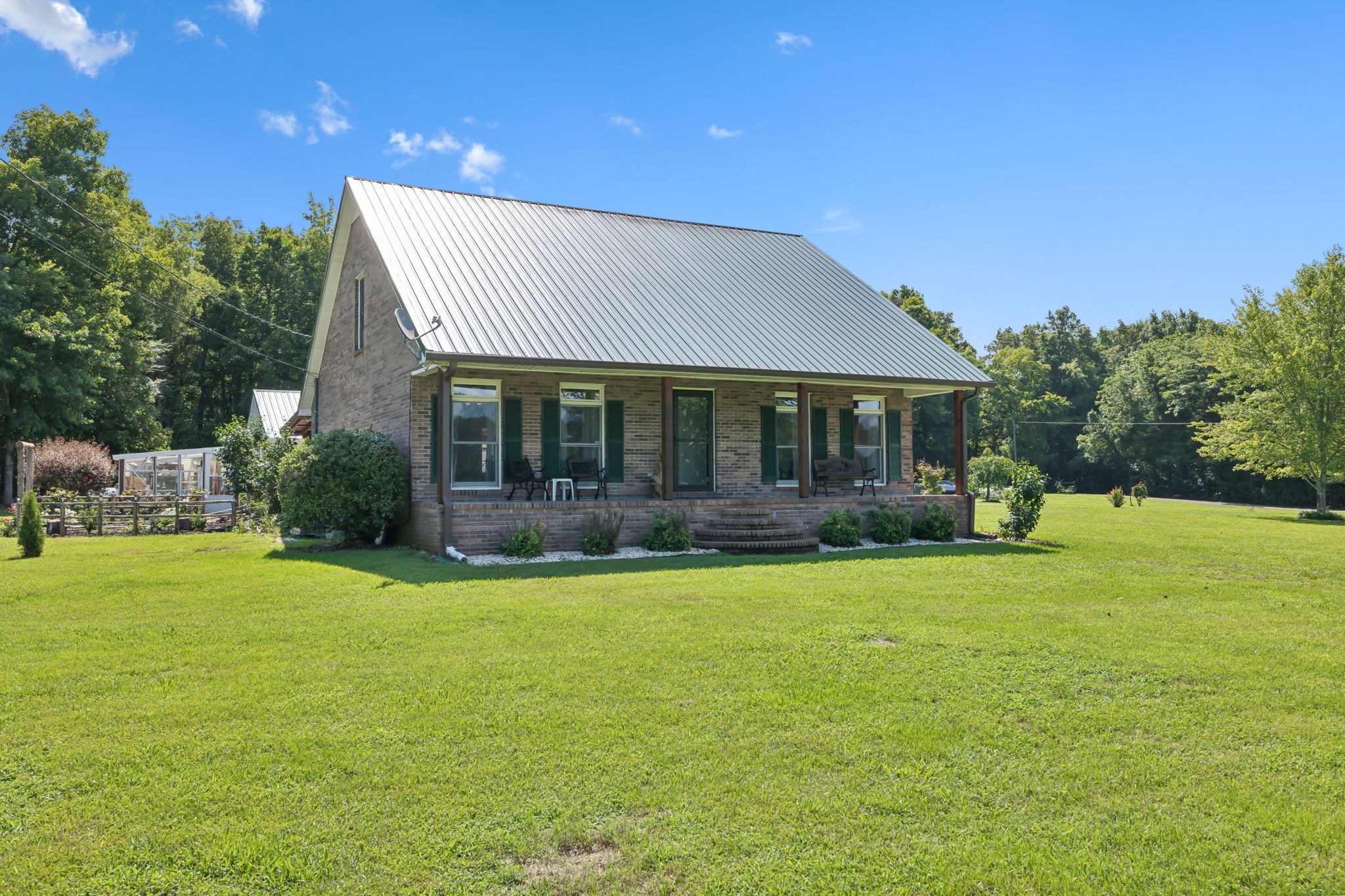 a front view of a house with a garden