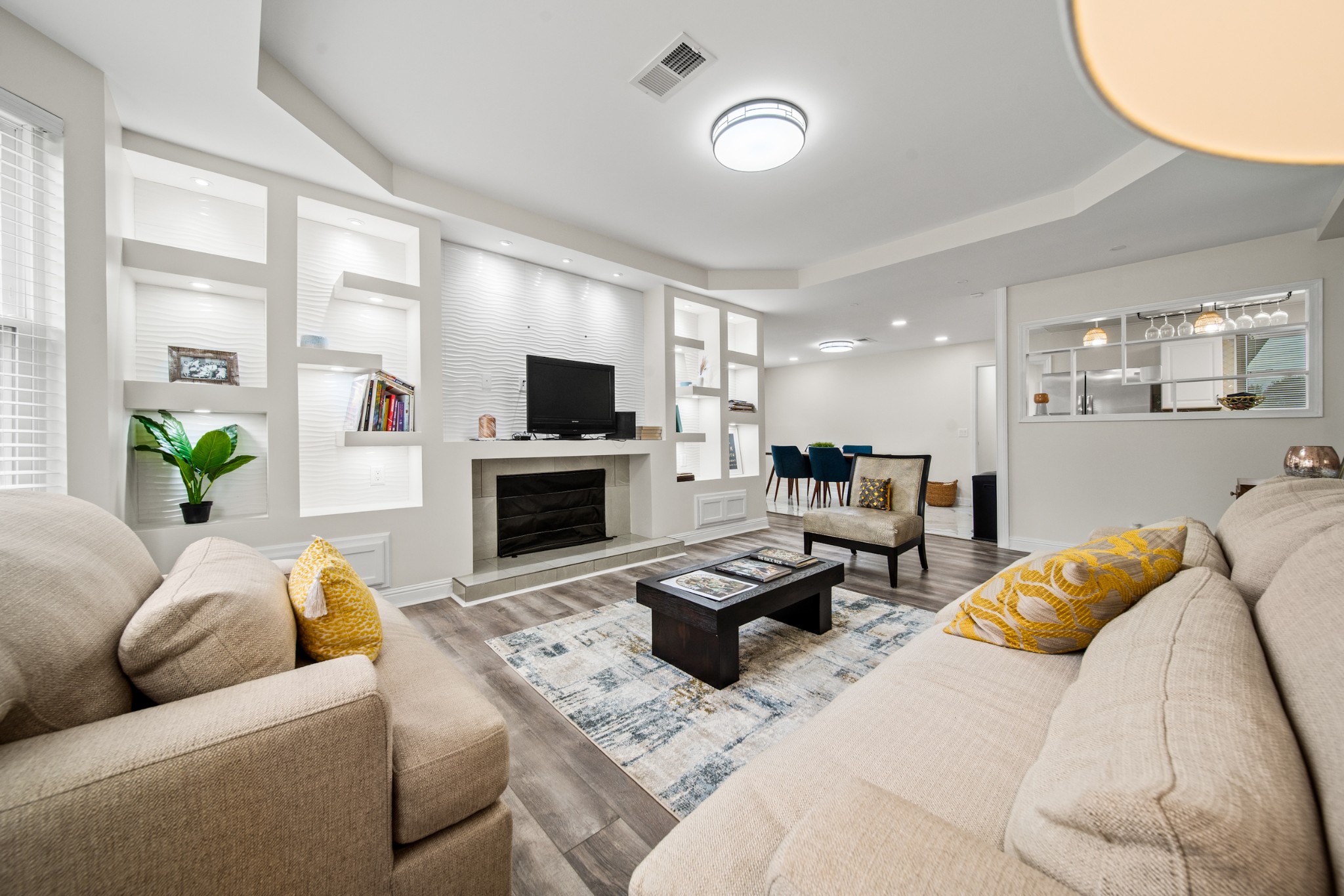 a living room with furniture a fireplace and a flat screen tv