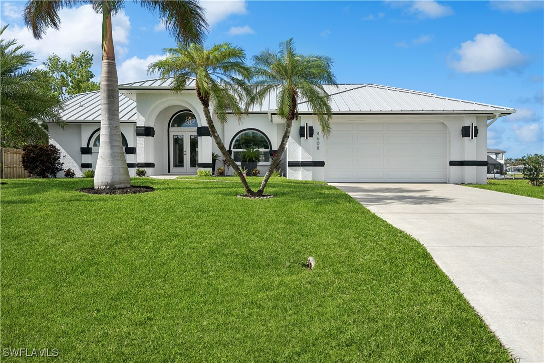 a front view of house with yard and swimming pool