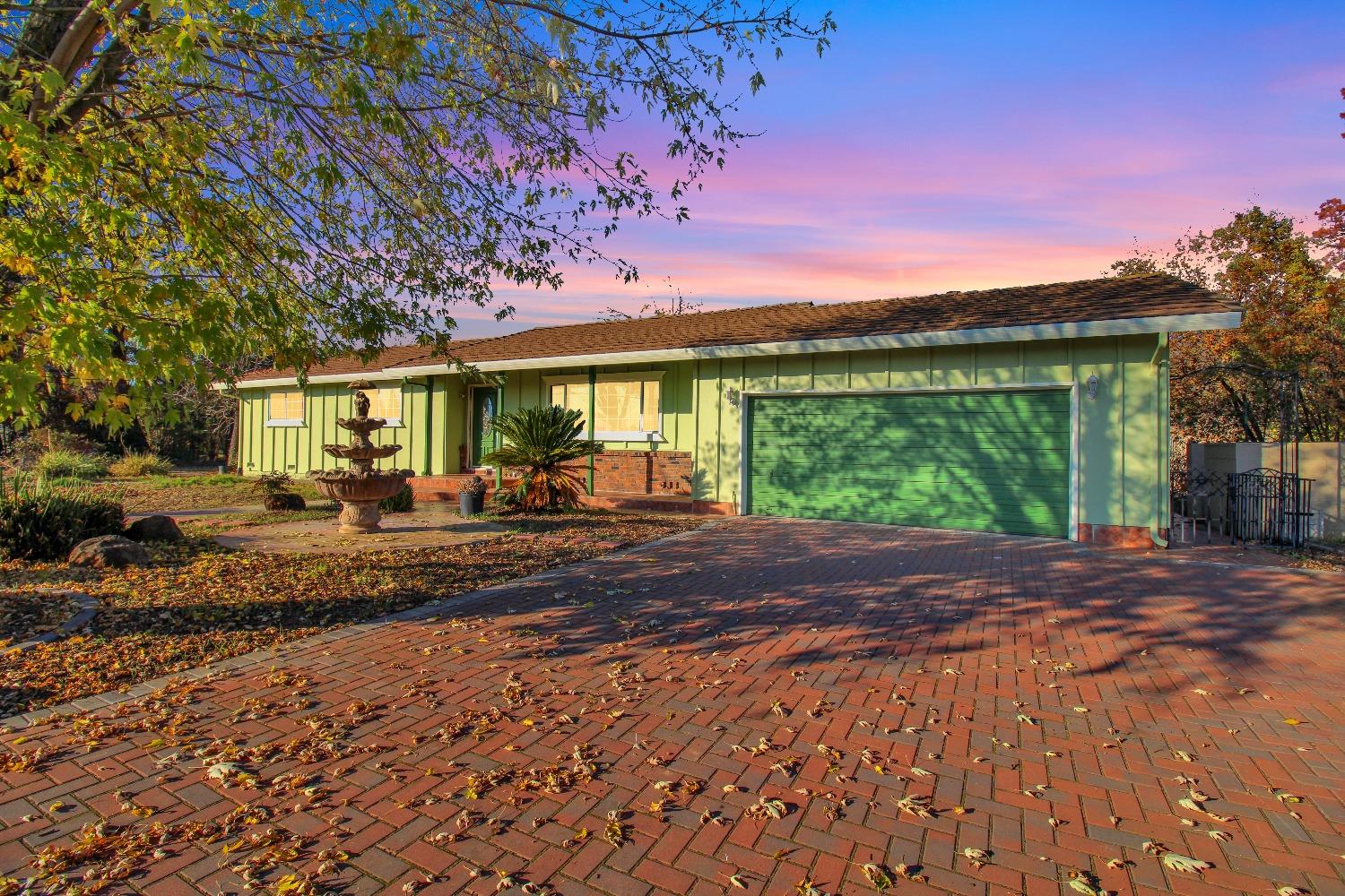 a view of a house with backyard and a patio