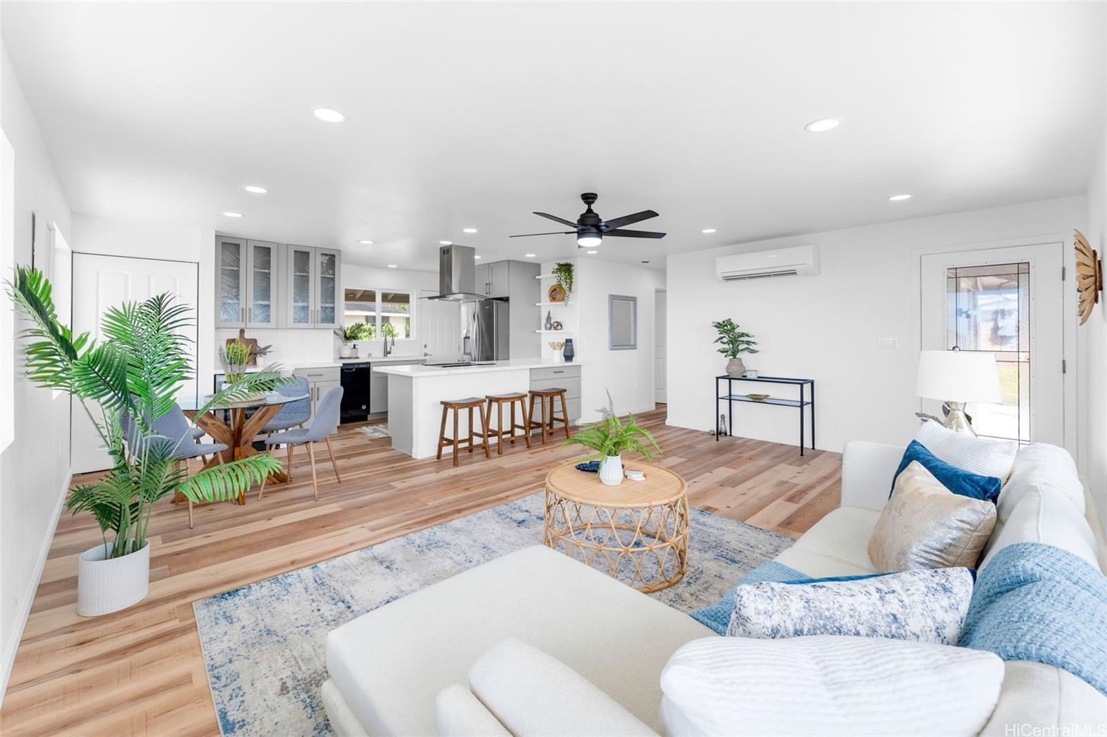 a living room with furniture and wooden floor