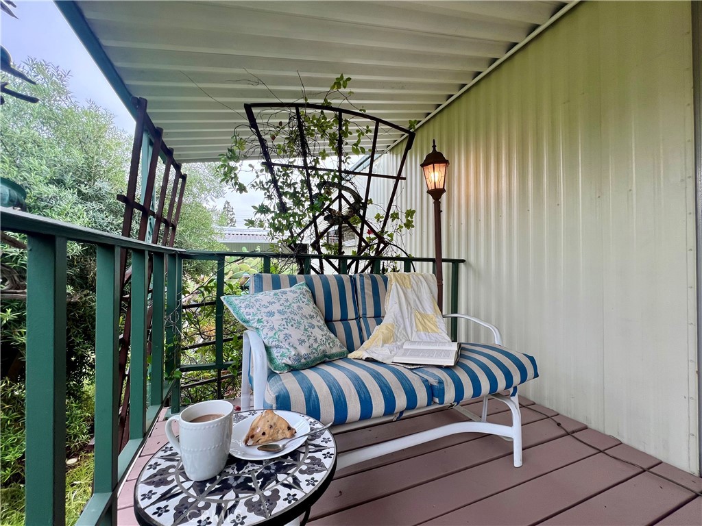 a balcony with furniture and a potted plant