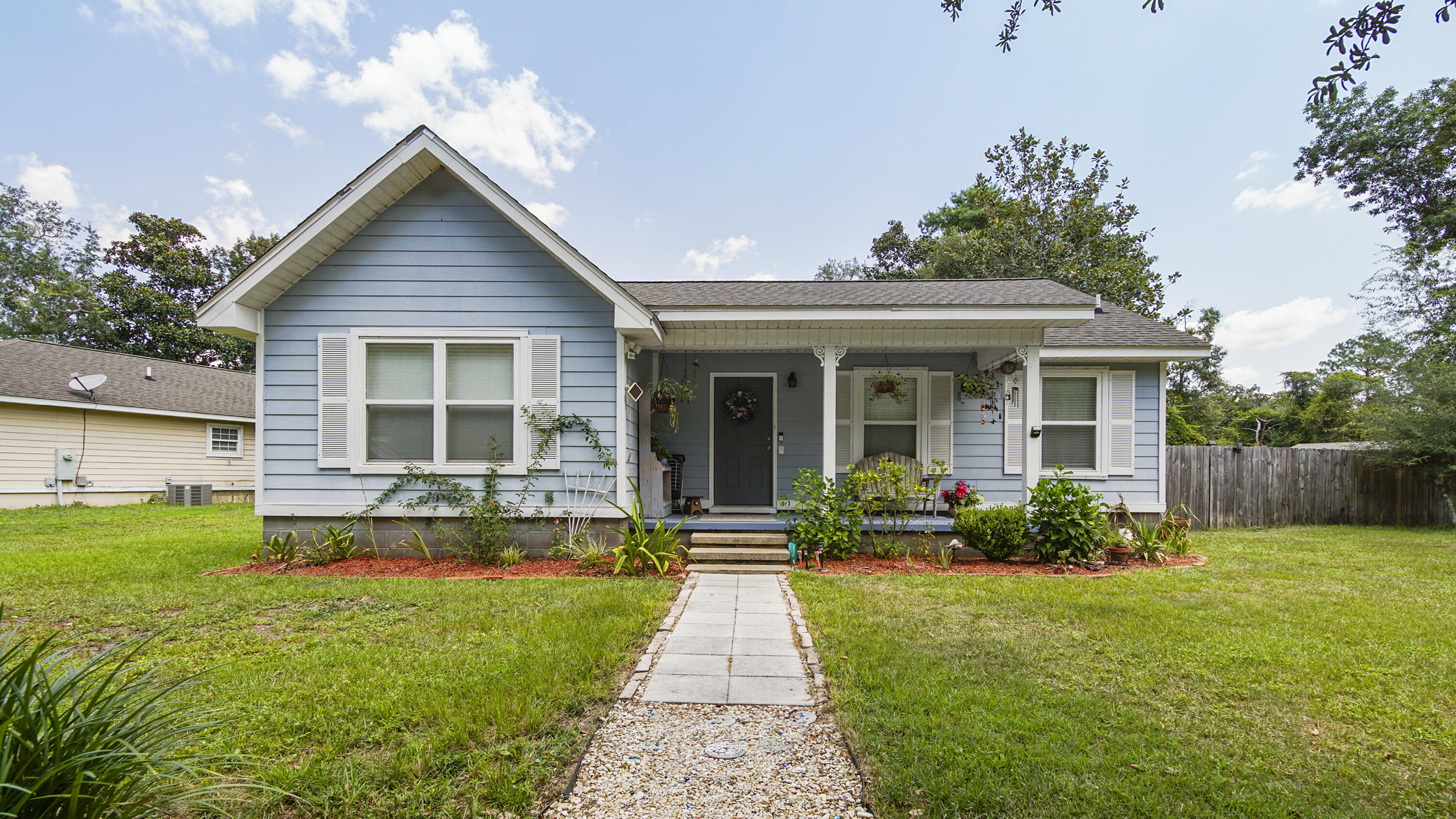 a front view of a house with garden and porch