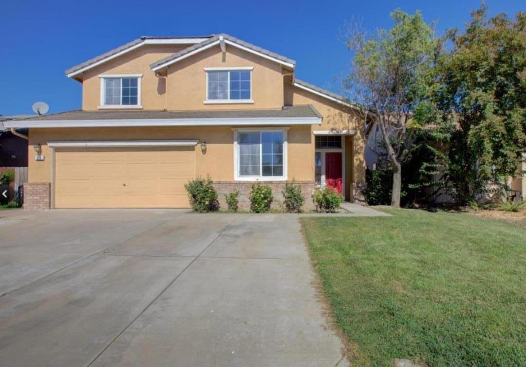 a front view of house with yard and green space