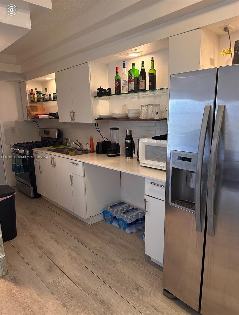 a kitchen with cabinets and stainless steel appliances