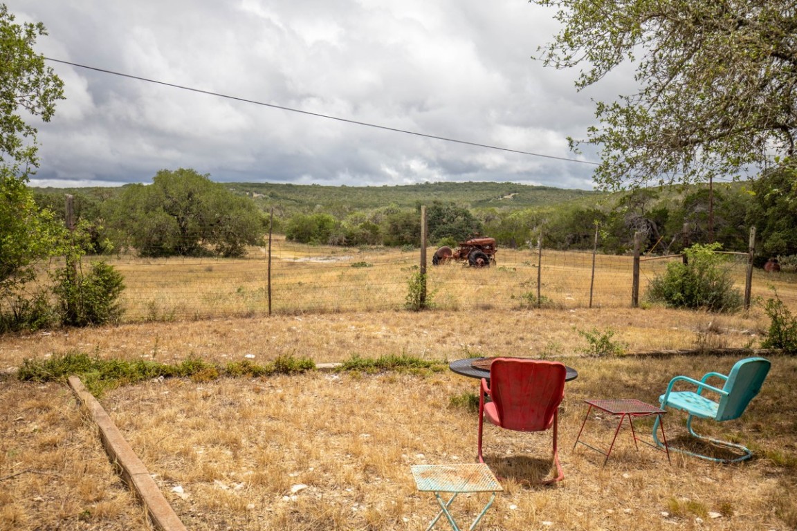 a backyard of a house with table and chairs