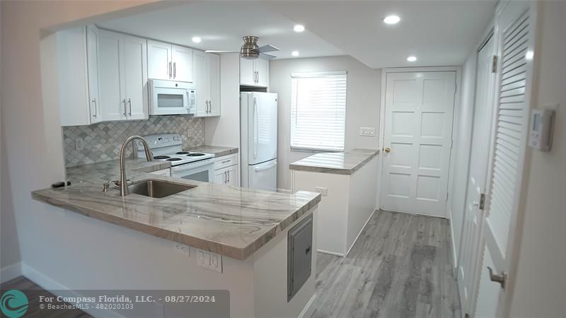 a kitchen with a sink stove and refrigerator