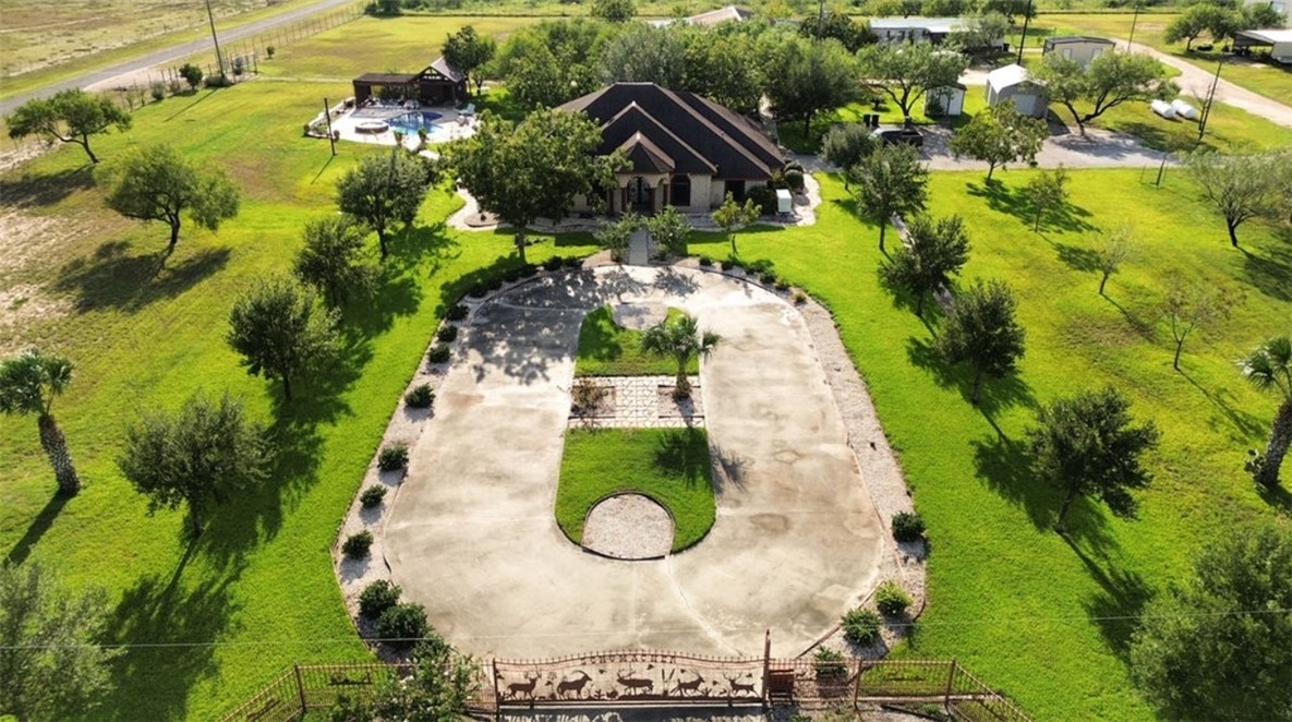 an aerial view of a house with a yard