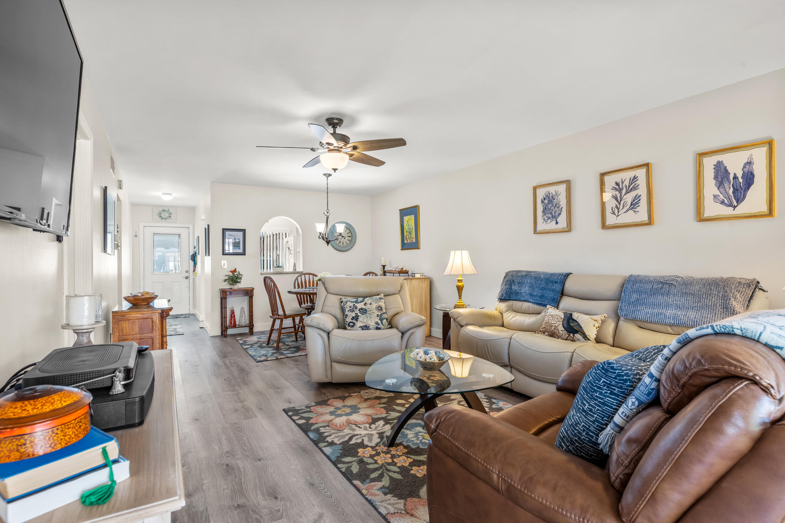 a living room with furniture or couch and a chandelier