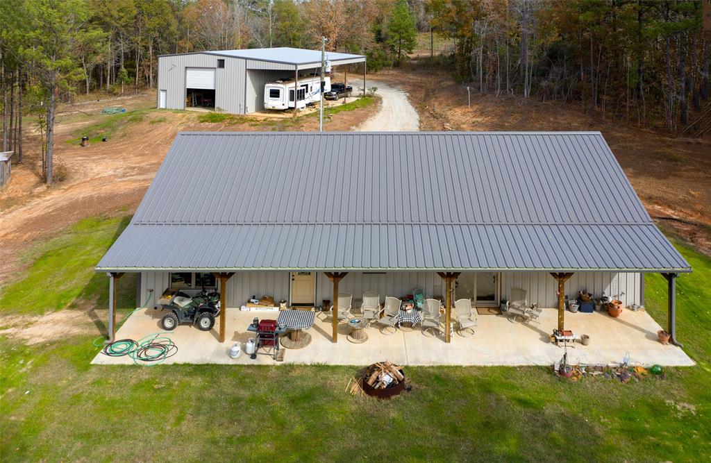 a view of a house with backyard and sitting area