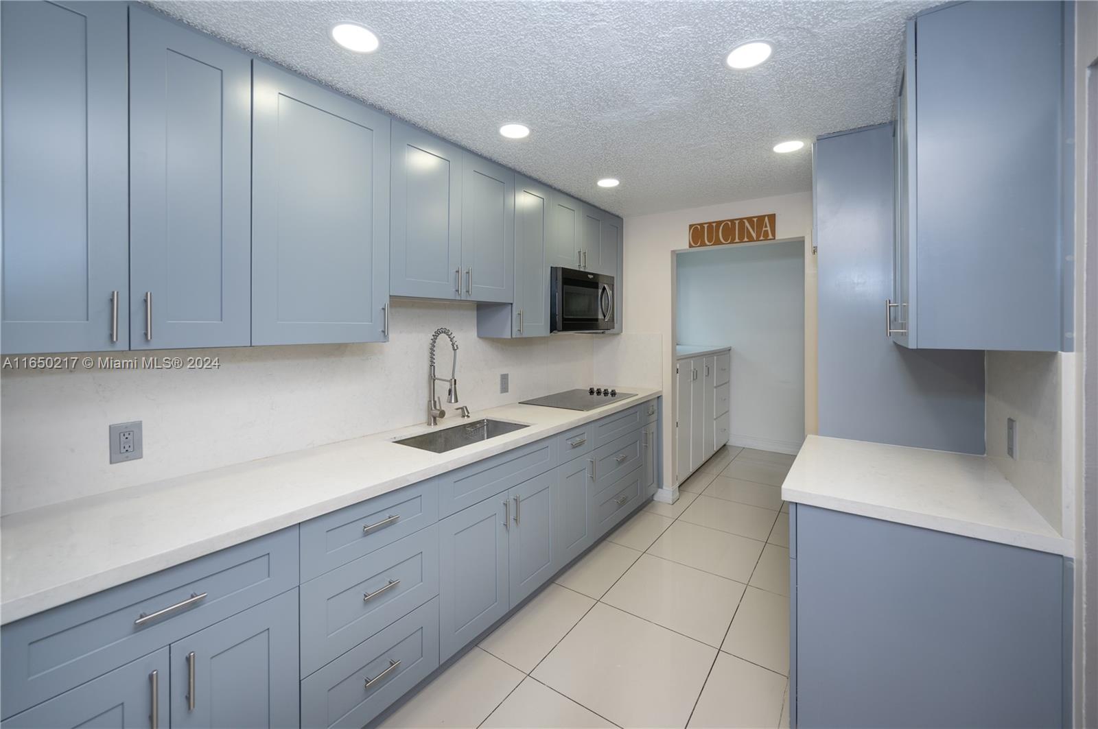 a kitchen with a sink stainless steel appliances and cabinets